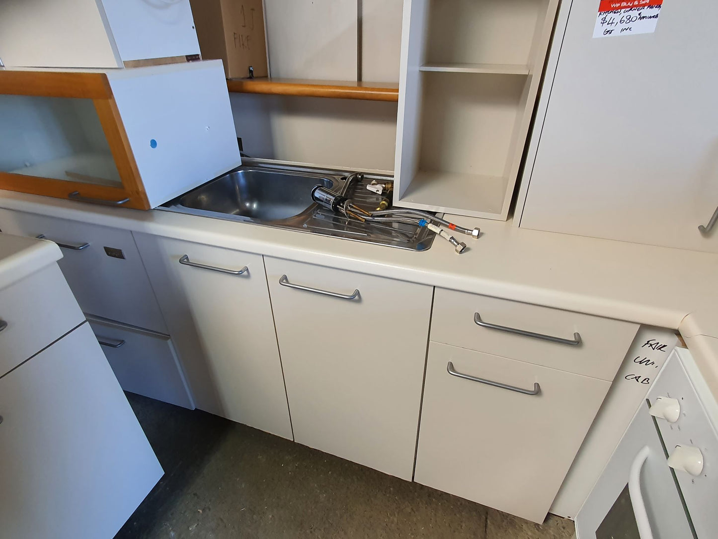 Compact Kitchen with Appliances and Corner Pantry