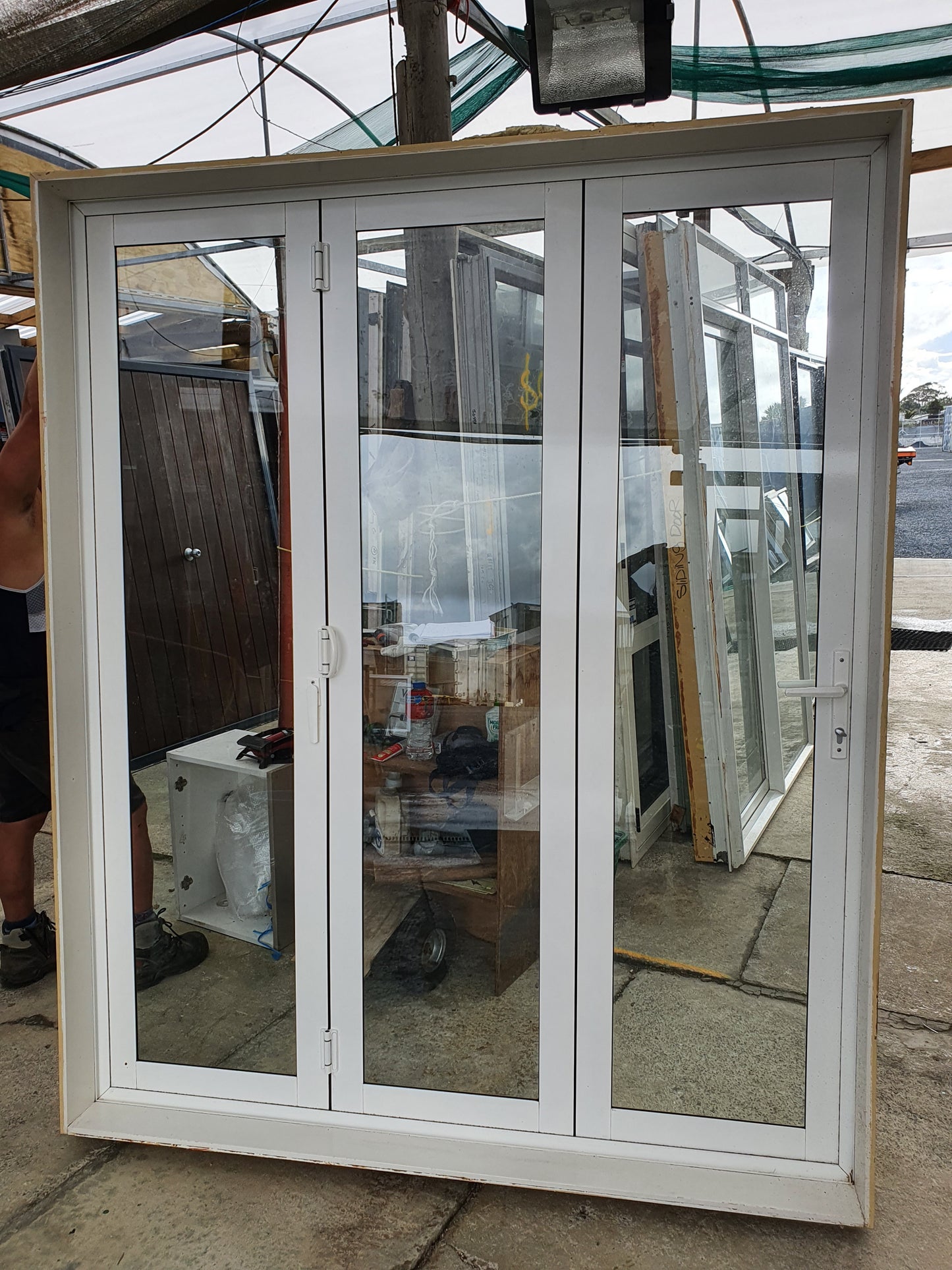 Off White Bifolding Door with Outside Access Door 2110 H x 1750 W #BDC6