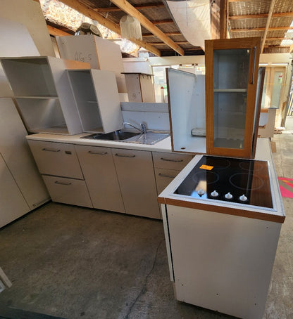 Compact Kitchen with Appliances and Corner Pantry