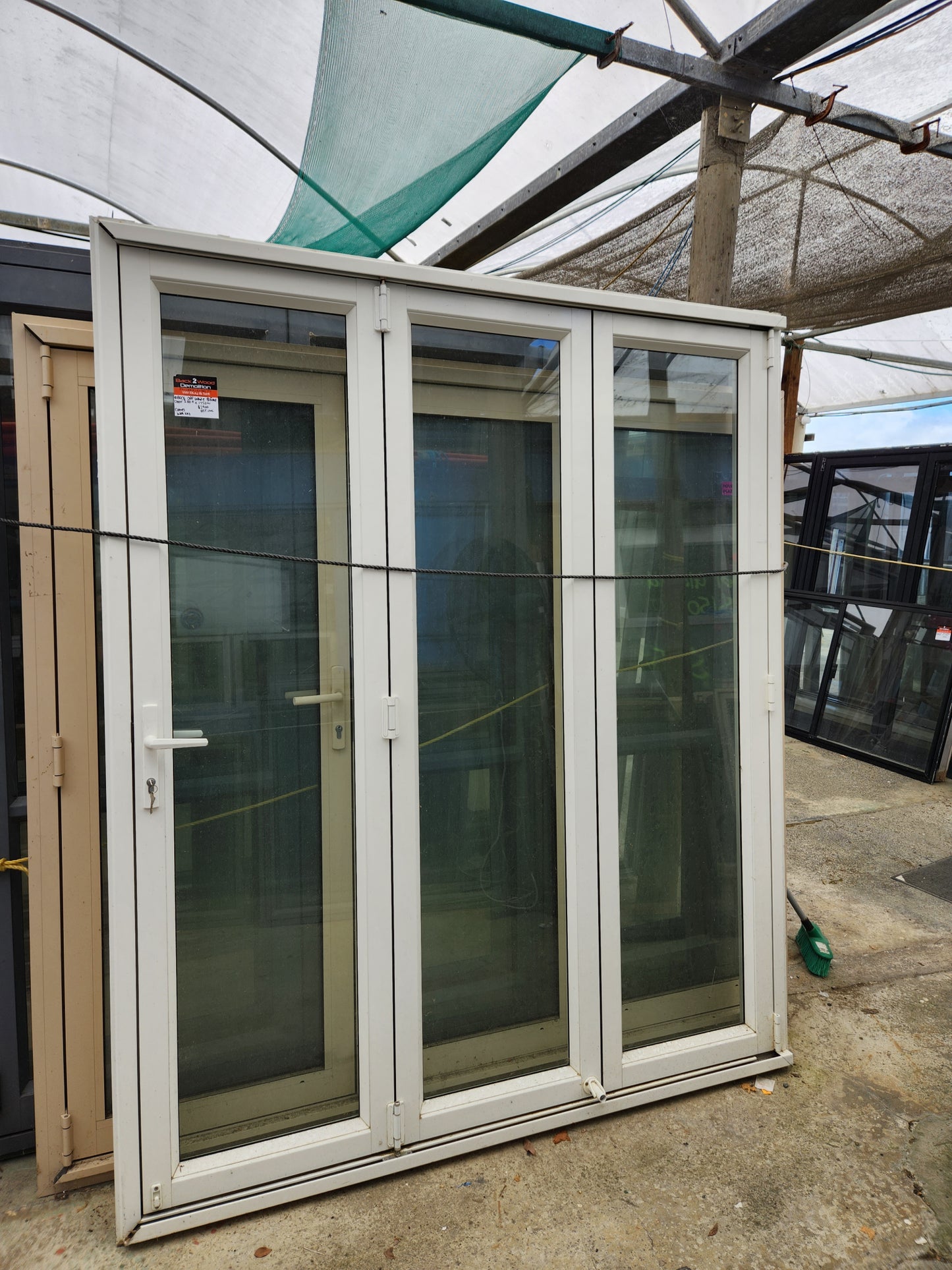 Off White Bifolding Door with Outside Access Door 2110 H x 1750 W #BDC6